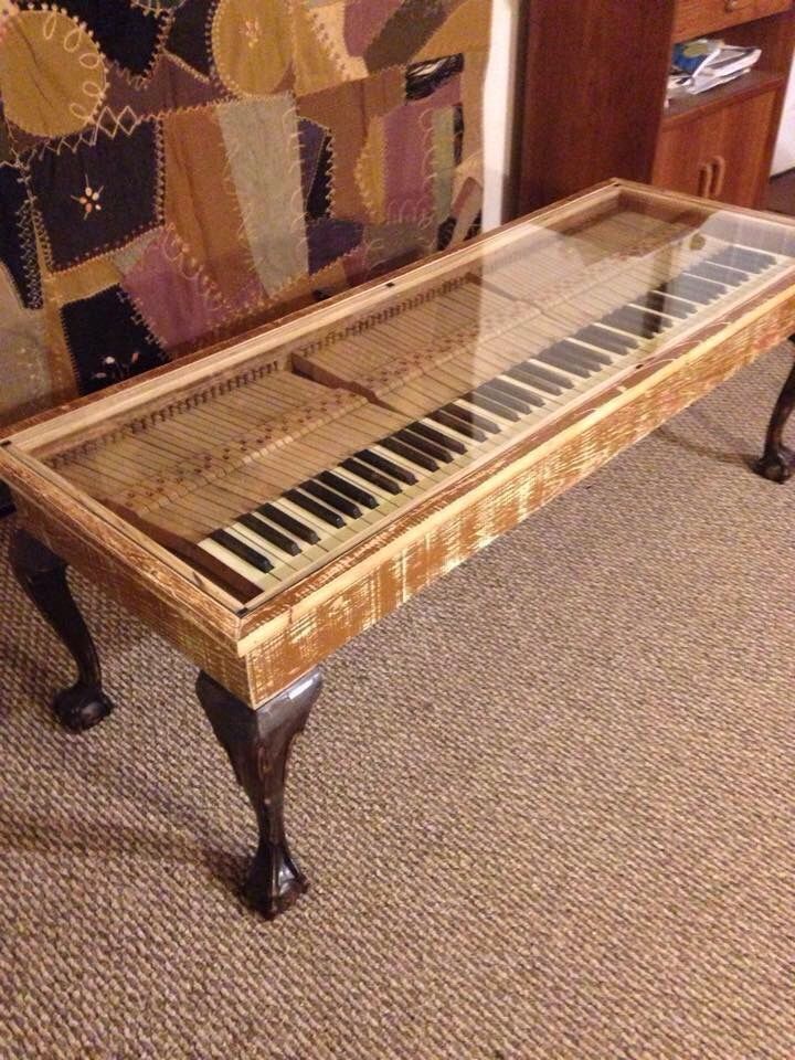 an old piano sitting on top of a carpeted floor