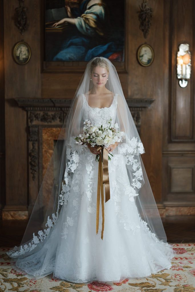 a woman in a wedding dress holding a bouquet