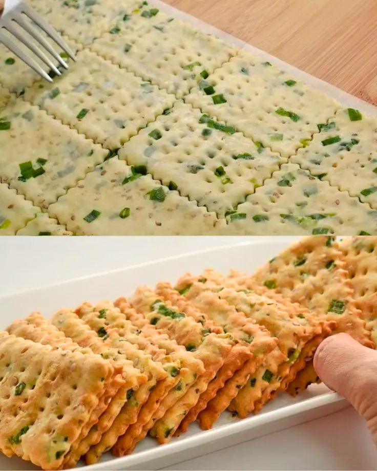 there is a white plate with crackers on it and someone holding a fork in the middle