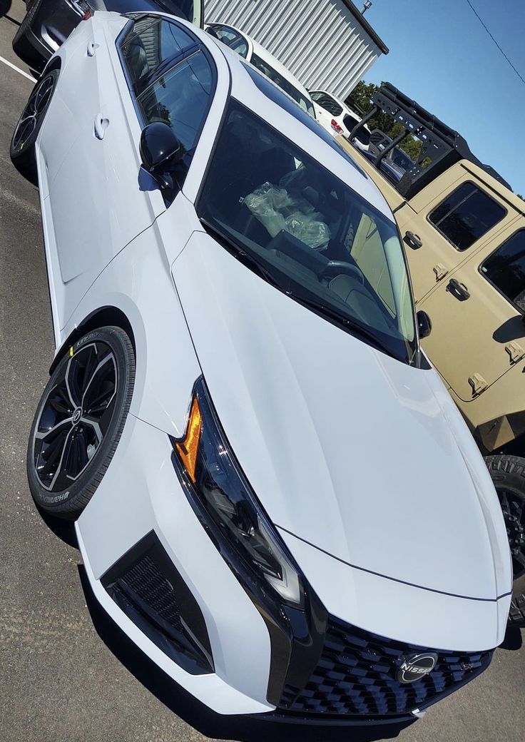 a white sports car parked in a parking lot