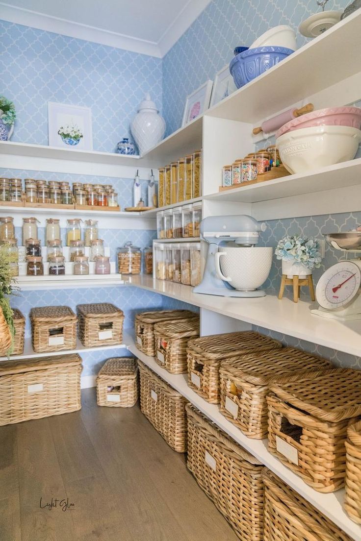 an organized pantry with wicker baskets and other items