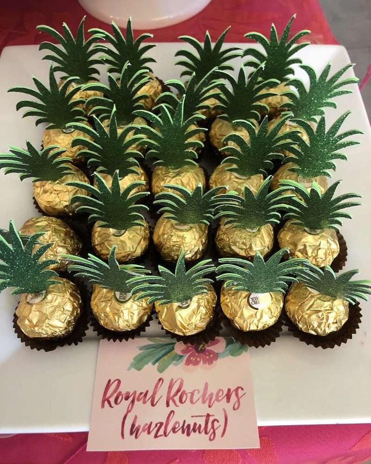 there are chocolates with pineapples on the top and gold foil around them