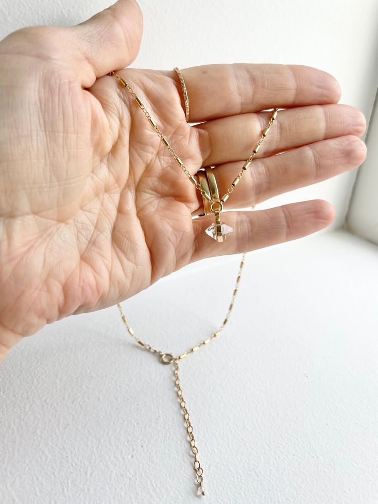 Such a gorgeous natural double terminated clear quartz crystal in a handmade 14k gold filled setting so simple and elegant hanging on lovely 14k gold filled fancy tube bead chain. This little Herkimer diamond is on a 18 inch chain with a 2 inch extender finished with a tiny faceted clear quartz bead. With a 14k gold filled spring ring closure attached by a mini faceted clear quartz crystal. A perfect treat for yourself or gift for a special someone🥰 Herkimer Diamonds are naturally, double-termi Delicate 14k Gold Teardrop Pendant Jewelry, Delicate Silver Charm Necklace In 14k Gold Filled, Dainty Briolette Jewelry With Delicate Chain, Delicate Dangle Jewelry With Adjustable Chain, Delicate 14k Gold Filled Silver Jewelry, Delicate 14k Gold Filled Jewelry In Silver Color, 14k Gold Wire Wrapped Necklace As Gift, Dainty Dangle Birthstone Jewelry, Minimalist Charm Necklaces With Delicate Dangle Chain