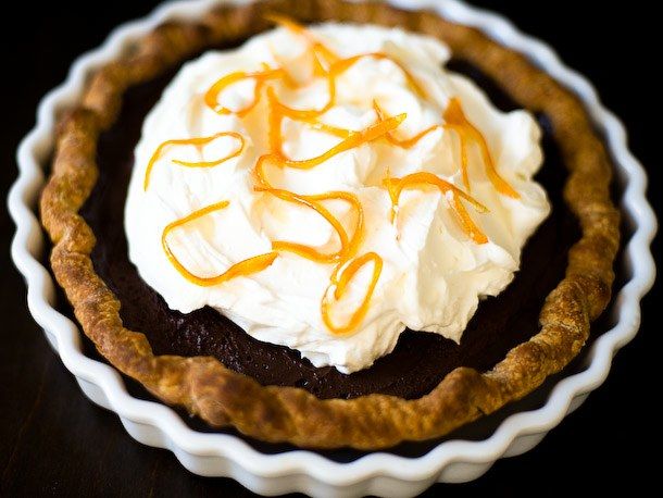 a chocolate pie topped with whipped cream and caramel drizzle