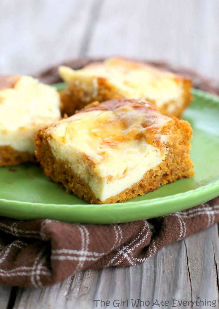 three pieces of cheesecake on a green plate with a brown and white checkered napkin