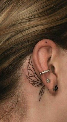 a woman's behind the ear tattoo