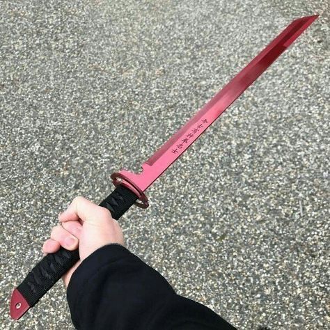 a person holding a knife in their hand on the street with no one around it