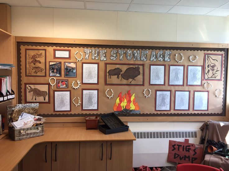 the stone age office is decorated with pictures and letters on the wall, along with other items