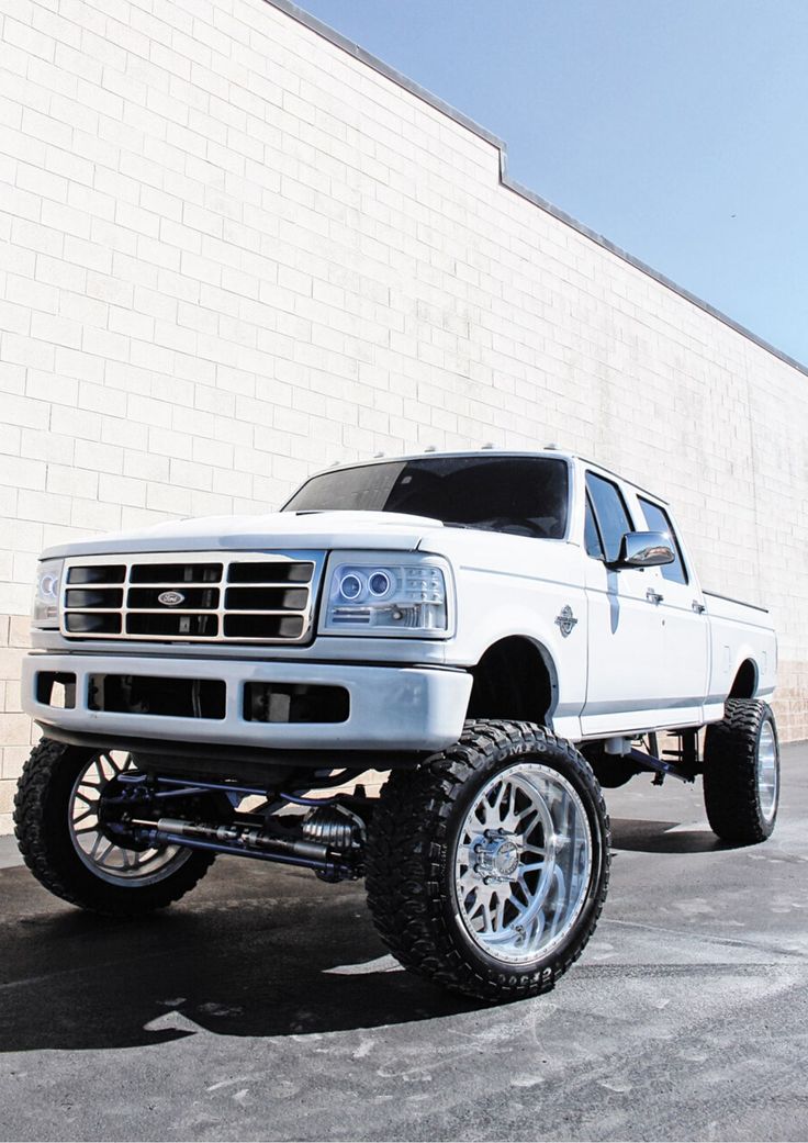 a white truck parked in front of a building