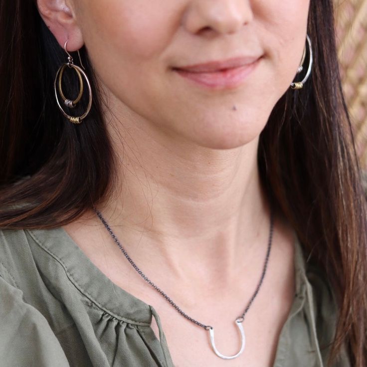 This simple necklace resembles a horse shoe and serves as a ring holder. I had a request from a massage therapist, she wanted a necklace that she could hang her wedding ring from so she could have her hands free. Hammered sterling is united by oxidized sterling chain. Great on it's own or with long layers. (RING IN 2ND PHOTO NOT INCLUDED) 1" wide, 16" sterling chain Hoop Jewelry With Adjustable Chain For Everyday, Everyday Hoop Jewelry With Adjustable Chain, Everyday Sterling Silver Hoop Necklaces, Hammered Jewelry As A Gift, Hammered Jewelry For Gifts, Horseshoe-shaped Jewelry With Adjustable Chain, Unique Necklaces For Everyday Wear, Unique Hammered Jewelry, Everyday Wire Wrapped Necklaces