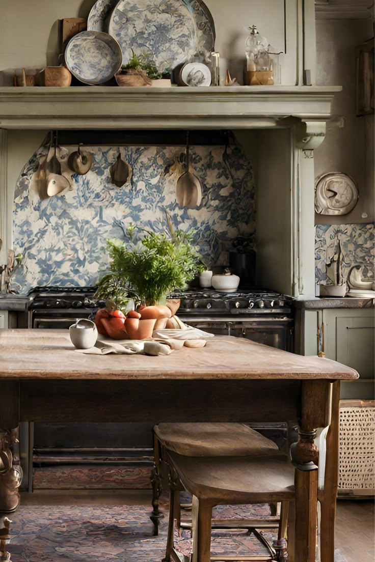 an old fashioned kitchen with blue and white wallpaper, wooden table and stools