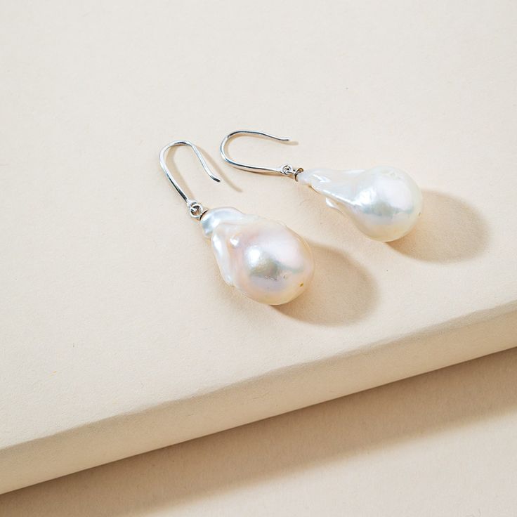 Pearls are the ultimate symbol for wisdom. Valued for their calming effects, pearls represent serenity, integrity, purity & loyalty.  These beautiful #baroque pearl earrings are one of a kind and crafted by our artisan designers from hand-selected pearls. 🌊✨ Shop: https://lintonjewelry.com/collections/earrings/products/large-baroque-pearl-earrings  #pearlearrings #barqouepearlearrings Luxury Drop Pearl Earrings, Luxury White Drop Teardrop Earrings, Baroque Pearl White Earrings With Pearl Charm, White Akoya Pearl Earrings With High Luster, High Luster Drop Pearl Earrings, Formal Baroque Pearl Earrings, Teardrop Baroque Pearl Earrings With Pearl Charm, Classic Teardrop Baroque Pearl Earrings, Pearl White Drop Earrings With Pearl Pendant