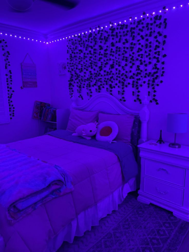 a bed room with a neatly made bed and purple lights on the wall above it