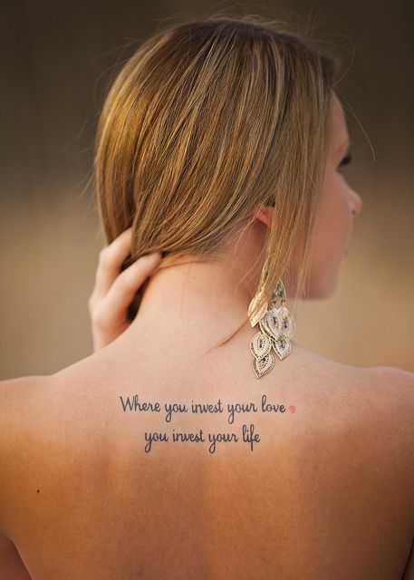 a woman with a tattoo on her back saying where you invest your love, you invest your life