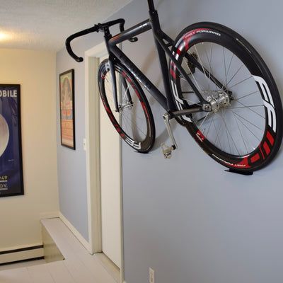 a bike hanging on the wall in a hallway