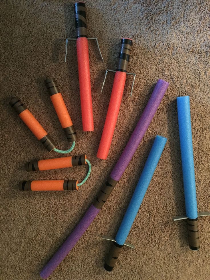 several different colored candles sitting on the floor