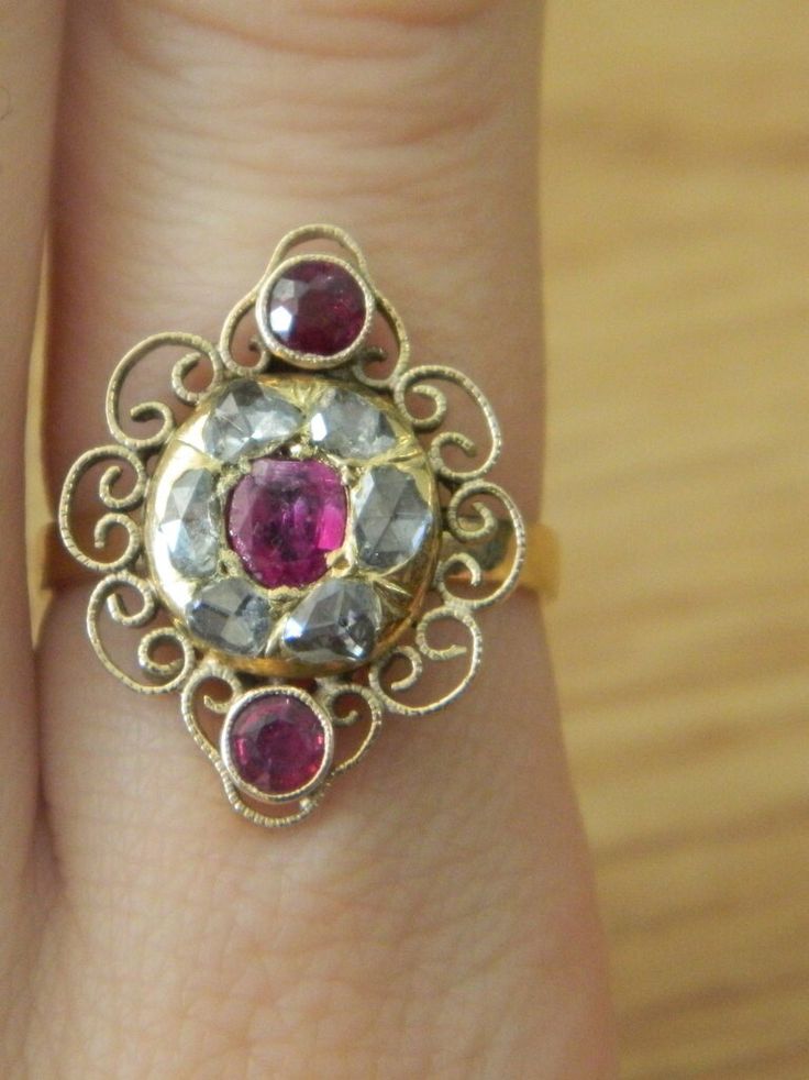 Main stone: man made ruby, diamont (.5ct) Setting is 14k solid gold   Size 6 1/4 Diameter is 20mm Weight is 5.6g  This is an antique ring, from mid 1800s. Looks like the band is not original, it has been replaced to match the main setting in 14K gold.   Can be resized upon request- at no extra charge. Vintage Ruby Ring With Rose Cut Diamonds, Antique Red Diamond Ring With Gemstone, Antique Ruby Ring With Single Cut Diamonds, Antique Ruby Rings With Single Cut Diamonds, Victorian Ruby Ring With Gold Center Stone, Victorian Gold Ruby Ring With Center Stone, Victorian Ruby Ring With Rose Cut Diamonds For Wedding, Antique Red Gemstone Diamond Ring, Victorian Ruby Ring With Rose Cut Diamonds