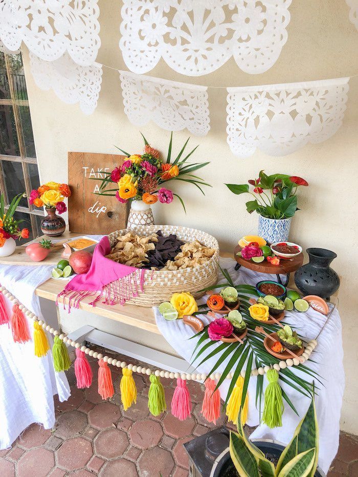 a table topped with lots of food and flowers