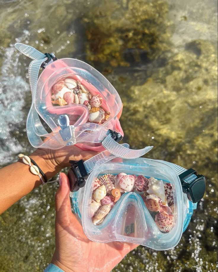 someone is holding up their snorkels to see what they are in the water