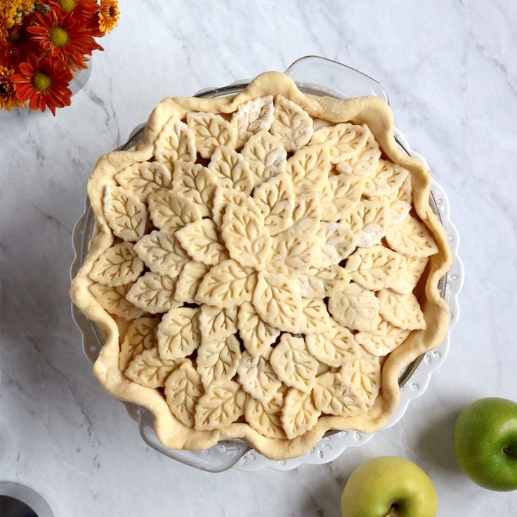 an apple pie sitting on top of a white counter