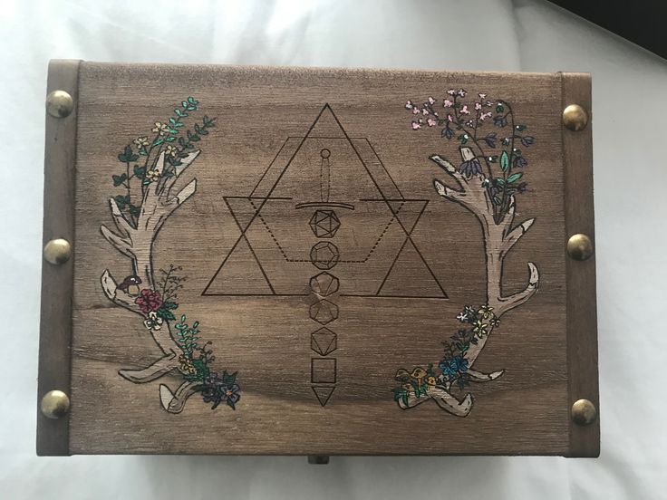 a wooden box with designs on it