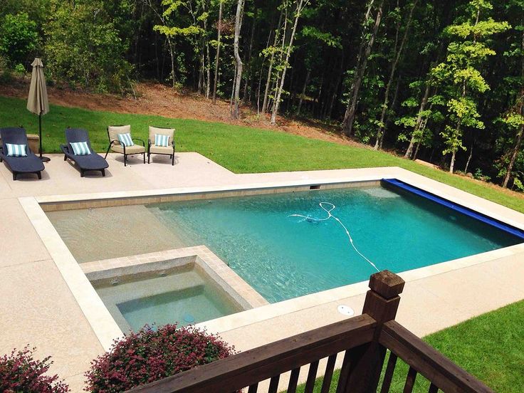 an empty swimming pool surrounded by lawn chairs