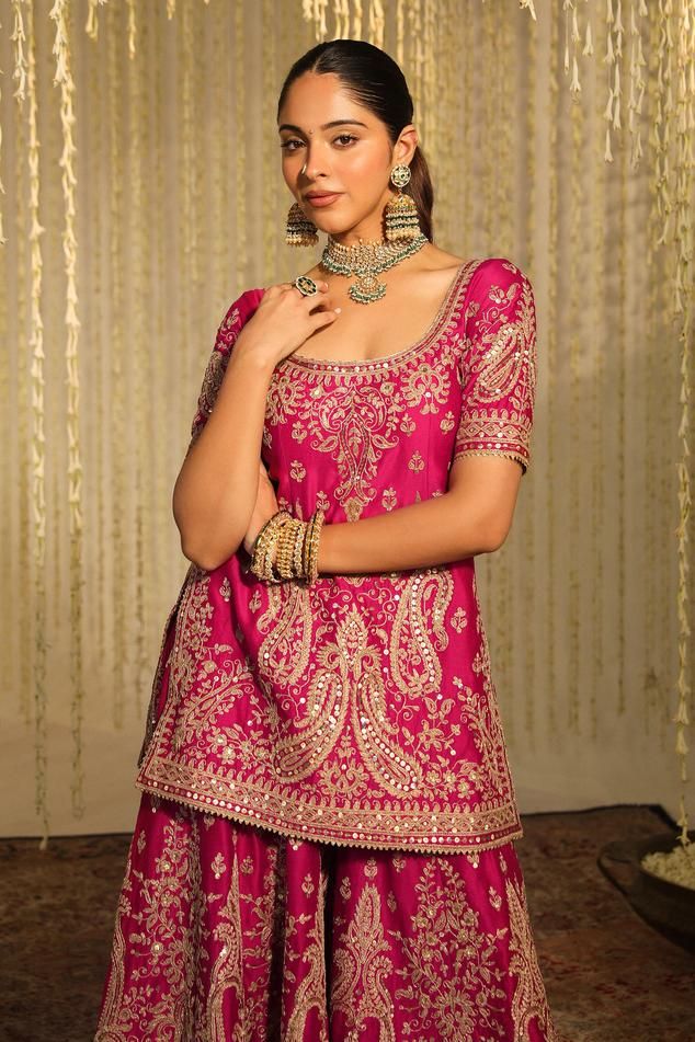 Hot pink silk chanderi kurta with thread embroidered paisley and floral motifs embellished by sequins. Comes with matching embroidered flared pant and banarasi kinari lined dupatta.
Components: 3
Pattern: Embroidered
Type Of Work: Thread, Sequin
Neckline: Round
Sleeve Type: Half
Fabric: Kurta and Bottom: Silk Chanderi, Dupatta: Silk Organza
Color: Pink
Other Details: 
Straight silhouette
Occasion: Wedding,Bride - Aza Fashions Unstitched Silk Choli With Chikankari Embroidery, Navratri Silk Choli With Chikankari Embroidery, Silk Choli With Chikankari Embroidery In Traditional Drape, Pink Banarasi Silk Kurta With Cutdana, Slub Silk Saree Sets With Intricate Embroidery, Traditional Sharara With Intricate Embroidery In Slub Silk, Pink Banarasi Silk Sets With Intricate Embroidery, Bollywood Silk Palazzo Set With Intricate Embroidery, Silk Sharara With Intricate Embroidery For Navratri