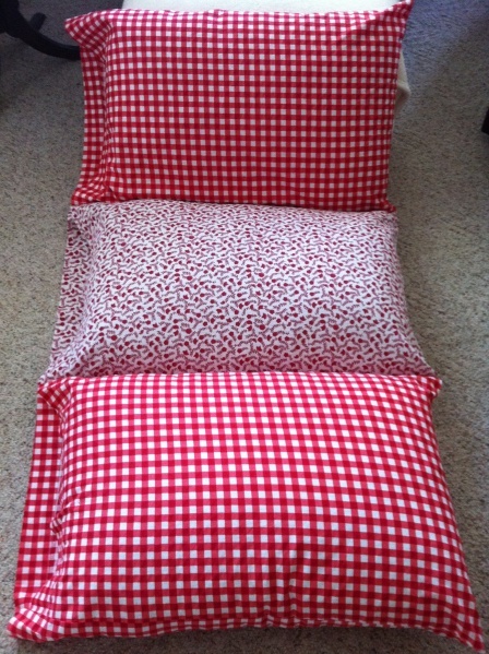 two red and white checkered pillows on the floor