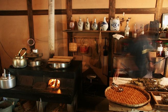 a man cooking food in an old fashioned kitchen