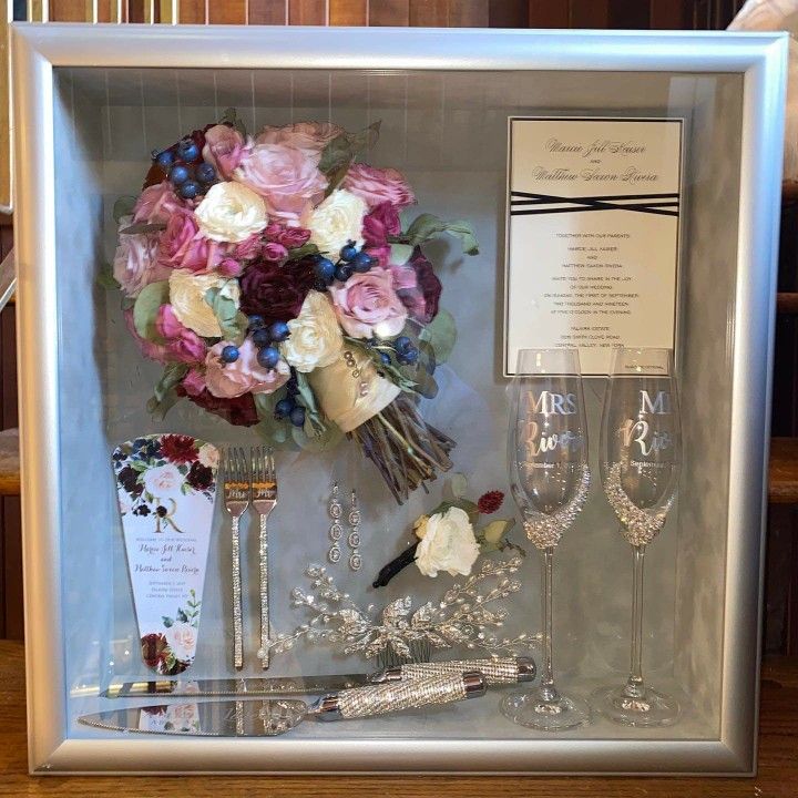 a display case with flowers and jewelry in it