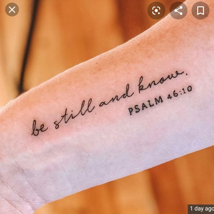 a person with a tattoo on their arm that says, be still and know jesus