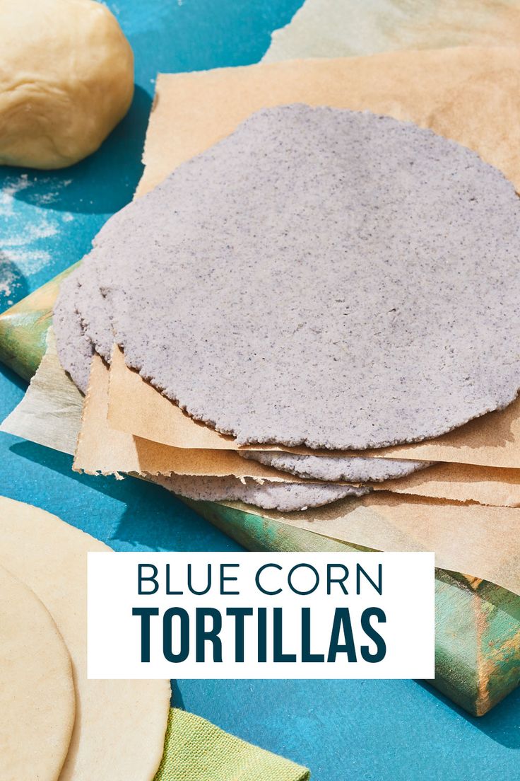 blue corn tortillas are sitting on top of parchment paper with the words, blue corn tortillas