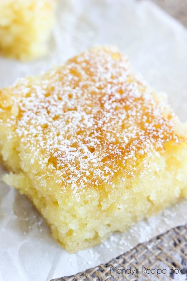 a close up of a piece of cake on a paper towel with powdered sugar