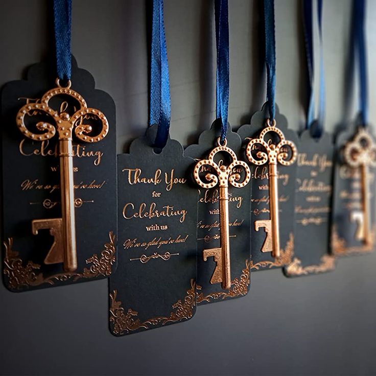 there are keys hanging on the wall with blue ribbon around them and tags that say thank you for celebrating