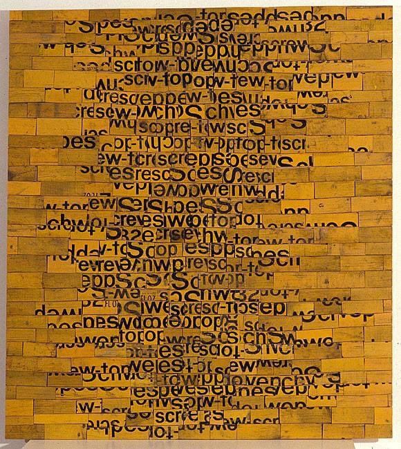 a piece of wood with words written in black and yellow on the bottom half of it