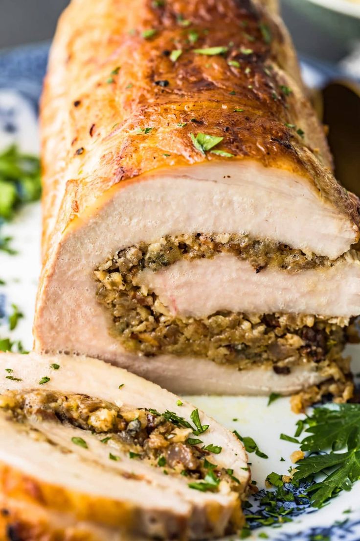 sliced meatloaf on a plate with parsley sprinkled around the edges