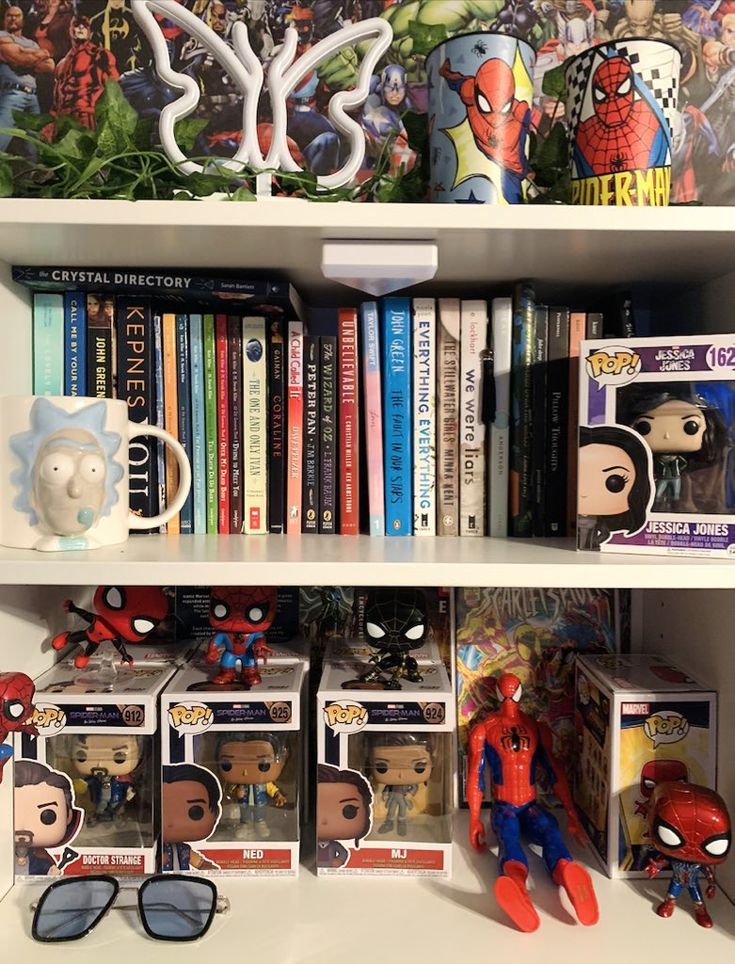 the shelves are filled with comic books and action figure figurines, including spider - man