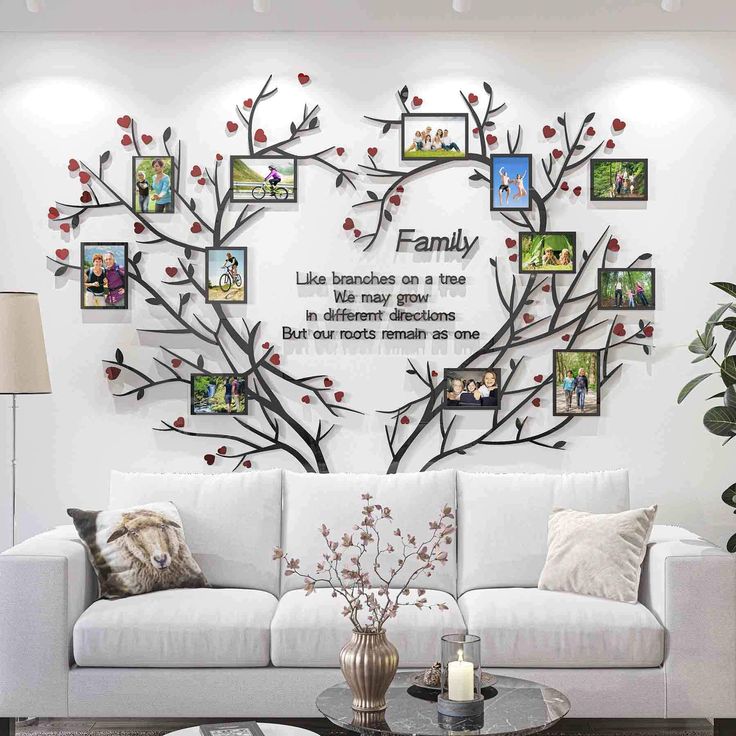 a living room with a white couch and pictures on the wall above it that says family