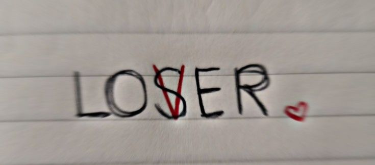 the word loser is written in black ink on a white background with red hearts