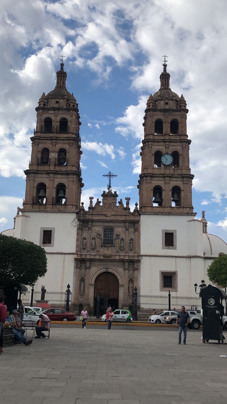 people are standing in front of an old church