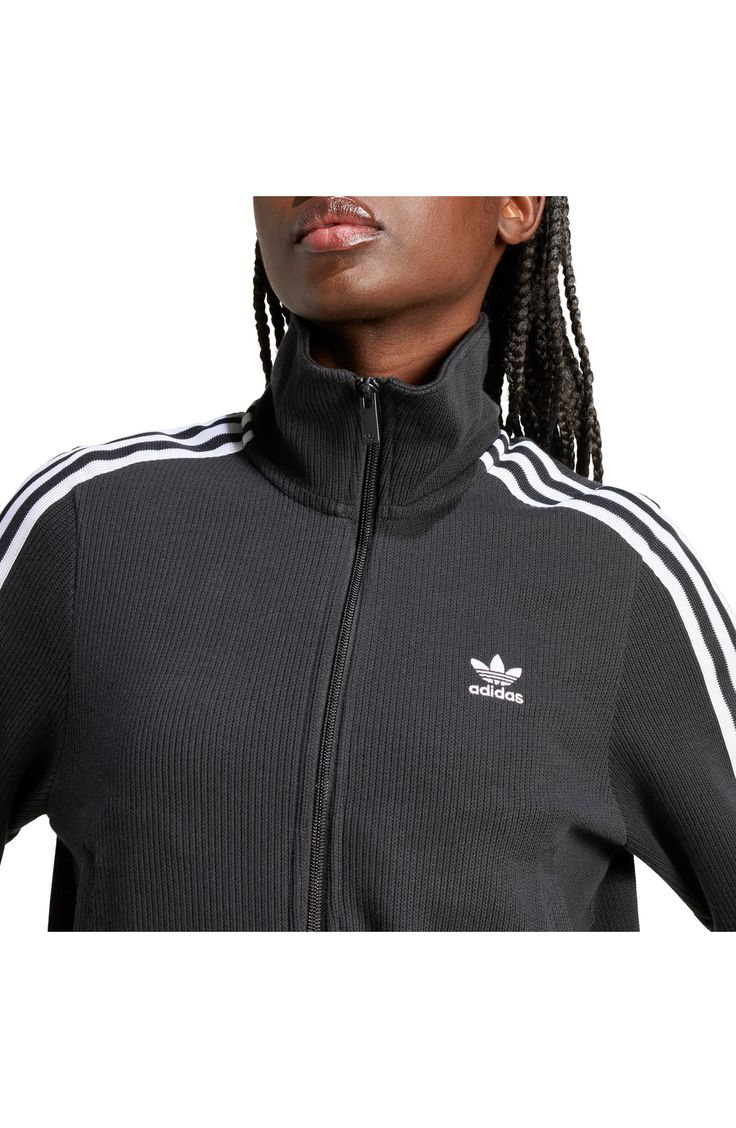 Made from a blend of cotton and recycled yarns, this ribbed track jacket with the 3-Stripes will keep you both comfy and sporty. Front zip closure Stand collar Front welt pockets 79% cotton, 21% recycled polyester Machine wash, dry flat Imported Casual Track Jacket With Side Stripes For Spring, Spring Casual Track Jacket With Side Stripes, Casual Spring Track Jacket With Side Stripes, Casual Track Jacket With Side Stripes For Fall, Fall Casual Track Jacket With Side Stripes, Athleisure Track Jacket With Side Stripes For Winter, Athleisure Winter Track Jacket With Side Stripes, Winter Athleisure Track Jacket With Side Stripes, Cotton Sportswear Track Jacket With Ribbed Cuffs