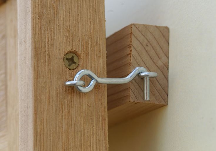 a close up of a door handle on a wooden door