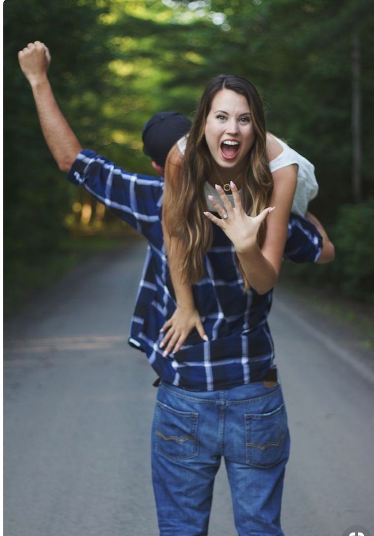 a young woman is riding on the back of a man's shoulders as he holds her