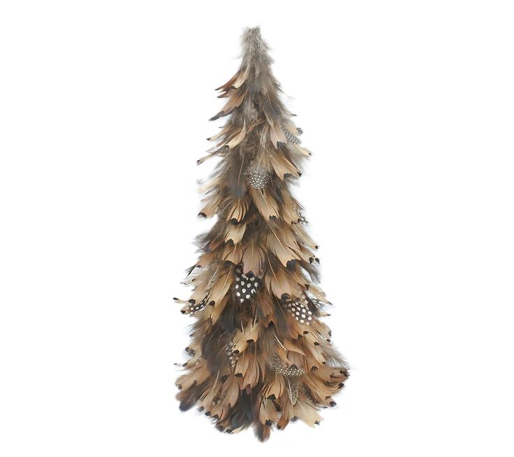 a feather christmas tree hanging on a white wall