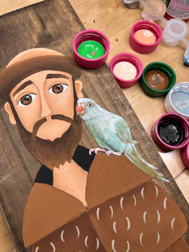 a painting of a man with a bird on his shoulder next to some paint cans