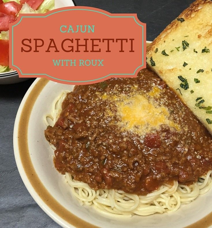 a white plate topped with spaghetti and bread