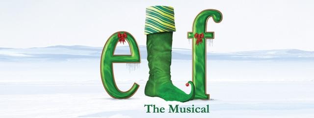 the broadway musical elf logo with green boots and hat on it's head, in front of snow covered ground