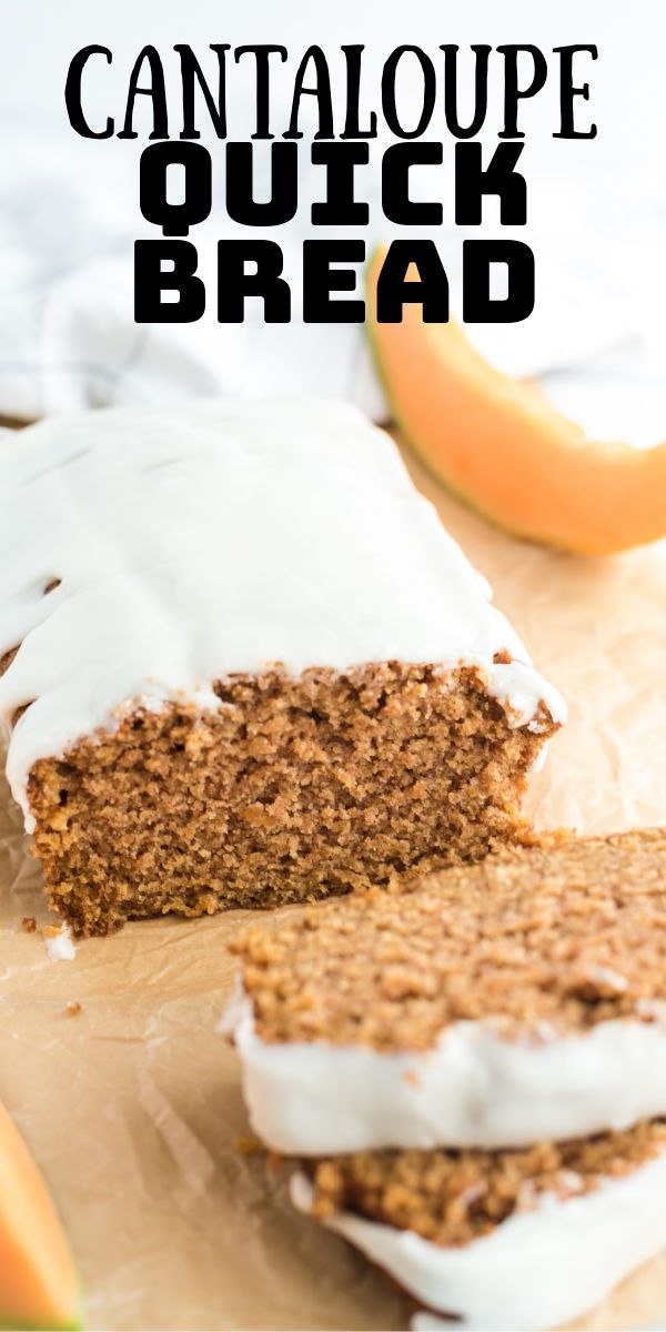 a close up of a piece of cake with frosting and fruit in the background