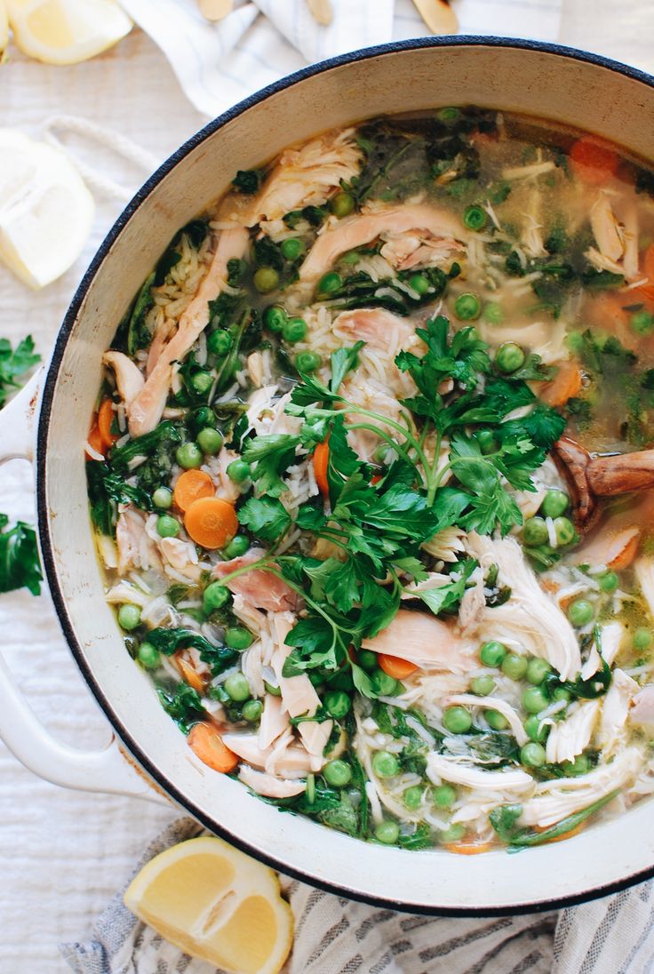 a pot filled with chicken and vegetables on top of a table