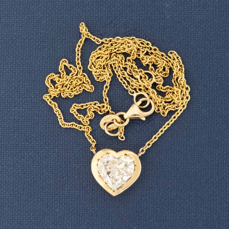 This reclaimed heart shape diamond, now set in this chunky yellow gold bezel is only the most charming pendant ever! The diamond is a spready "fat" heart, with delicious broad facets. Beyond charming, sitting nice and low on the neck. 18kt yellow gold Chain measures 18" Diamond is estimated to be O/P color & VS2 clarity. GIA Standards Please see qualitative report for more information. Luxury Heart-shaped Jewelry With Bezel Setting, Gold Heart Necklace With Single Cut Diamonds For Gift, Gold Heart Necklace With Single Cut Diamonds, Gold Heart Necklace With Single Diamond, Gold Heart-shaped Rose Cut Diamond Jewelry, Gold Heart Shaped Jewelry With Rose Cut Diamonds, Gold Heart Jewelry With Bezel Setting, Gold Heart Necklace With Single Cut Diamonds For Anniversary, Yellow Gold Heart-shaped Rose Cut Diamond Jewelry